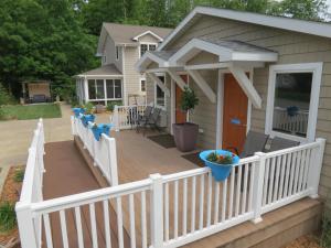 a deck with a white fence and a house at Bodee's Bungalow Adults Only Couples Only Boutique Hotel in Put-in-Bay