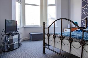 a bedroom with a bed and a desk with a computer at 33 Turner street in Redcar