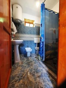 a bathroom with a sink and a toilet and a shower at Guest House Gjelaj in Theth