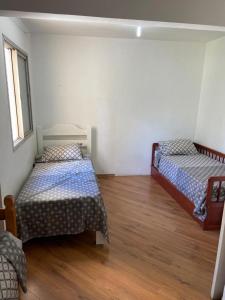 a room with two beds and a wooden floor at Apartamento Giovanni Gronchi in Sao Paulo +11 photos