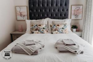 a bedroom with a bed with towels on it at Stylish Belfast City Centre 2 Bedroom Apt Free Parking in Belfast +8 photos