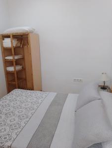 ネルハにある1 Pasaje Fuente de Cantareroの白いベッドルーム(ベッド1台、棚付)