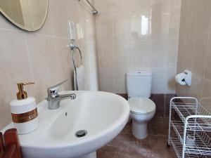 a bathroom with a sink and a toilet at HomeSweetHome in Paphos +13 photos