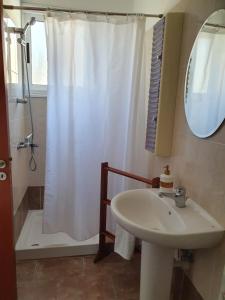 a bathroom with a shower curtain and a sink at HomeSweetHome in Paphos