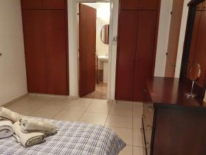 a kitchen with a bed with a towel on the floor at HomeSweetHome in Paphos