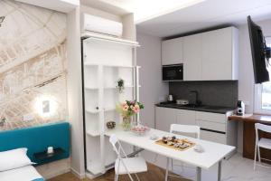 a small kitchen with a white table and chairs at Prestige House Luxury Suite in Pompei