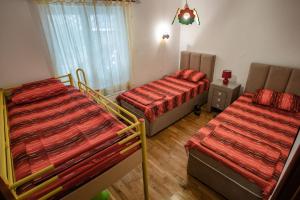 a room with two beds in a room at Ana Apartment in Kotor
