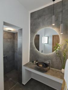 a bathroom with a sink and a mirror at Villa Konstantinos in Perissa +44 photos