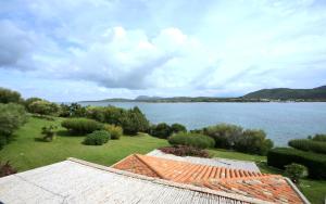 a house with a view of a large body of water at Hotel Palumbalza Porto Rotondo in Porto Rotondo