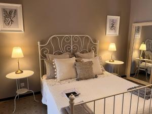 a bedroom with a bed with a metal headboard and pillows at Villa House and Garden B&B in Montichiari