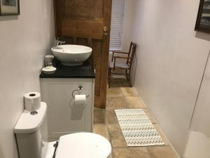 a bathroom with a white toilet and a sink at 4 Duke Street Flat#2 in Mossel Bay