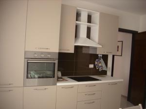 a kitchen with white cabinets and a stove top oven at Maria del Mar in Monopoli +53 photos