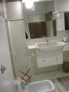 a bathroom with a sink and a mirror and a shower at Maria del Mar in Monopoli