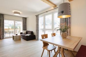 a living room with a table and a couch at Apart33 by Apart4you in Haus im Ennstal