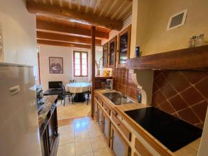 a kitchen with a sink and a refrigerator at Appartement 4 pers plein centre ville, wifi, balcon in Laragne