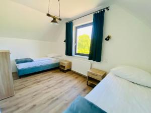Postel nebo postele na pokoji v ubytování Osada Jackowo + 23 fotografií