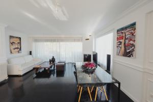 a living room with a white couch and a table at Sia's Luxury Maisonette in Pikérmion