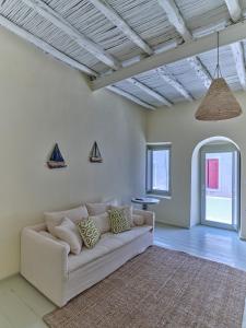 a living room with a white couch and a rug at Flair Naousa in Naousa