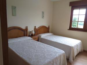 Cama o camas de una habitación en Apartamentos Turísticos La Senra