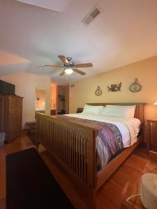 a bedroom with a bed and a ceiling fan at Bodee's Bungalow Adults Only Couples Only Boutique Hotel in Put-in-Bay