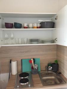 a kitchen with a sink and some bowls and plates at On the hill in Sasbachwalden