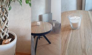una mesa con un vaso de leche y una vela en Le Celia, en Cavalaire-sur-Mer