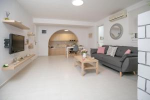 a living room with a couch and a table at Home Sweet Home in Ierápetra