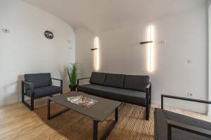 a living room with a couch and a table at r12 Apartments in Győr