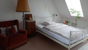 a bedroom with a bed and a red chair at Agnes Vintage Home in Hannover
