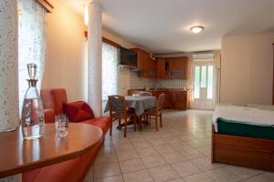 a living room with a kitchen and a dining room at Guest house Kočanija in Ilirska Bistrica
