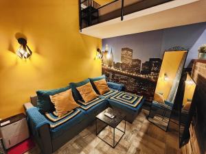 a living room with a blue couch and a city at King Apartment in Budapest