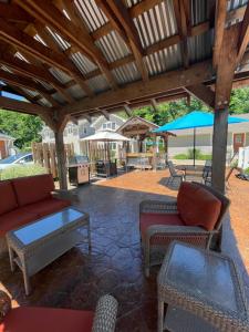 a patio with couches and chairs and a table at Bodee's Bungalow Adults Only Couples Only Boutique Hotel in Put-in-Bay