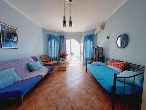 a living room with a bed and a couch at Leta apartments in Agios Georgios