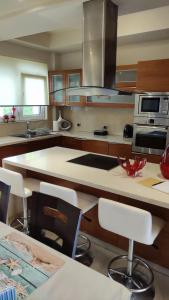 a kitchen with a large island in a kitchen at Villa Katerina in Ialyssos