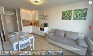 a living room with a couch and a table at Santhooft B , bus 514 Nieuwpoort bad in Nieuwpoort