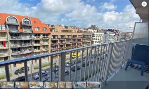 a balcony with a view of a parking lot with cars at Santhooft B , bus 514 Nieuwpoort bad in Nieuwpoort
