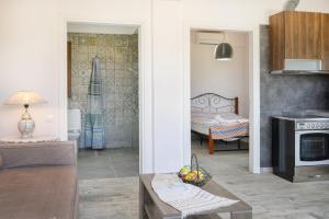 a living room with a couch and a table in a room at DANAI HOUSE 3 in Nea Roda