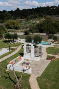 an external view of a garden with a swimming pool at Tenuta Marinelli in Cisternino