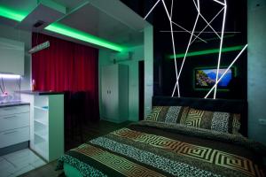 Foča Apartmani "Story Lux" في فوتشا: غرفة نوم بها سرير مع أضواء خضراء عليه