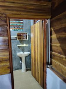 a bathroom with a toilet and a sink at Thambili cabanas whisky point in Arugam Bay