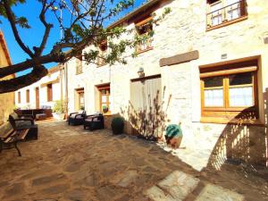 a courtyard of a building with couches at Casa Pinines in Torre Val de San Pedro