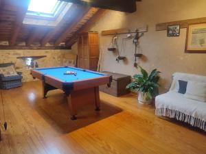 a living room with a pool table and a couch at Casa Pinines in Torre Val de San Pedro