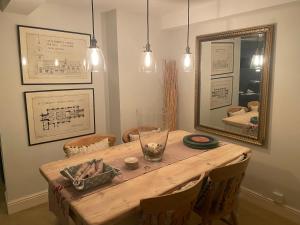 a room with a wooden table with a mirror at Waterside, Elmham Watermill, Norfolk in North Elmham