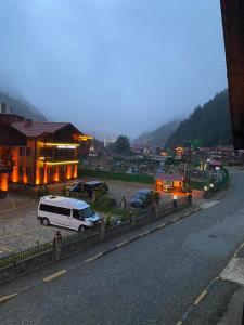 a van parked in a parking lot next to a building at Sarahome Apart in Uzungöl