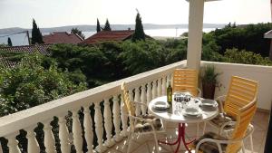 a table and chairs on a balcony with a view at Apartment Ribarica - Velebit Riviera 38418 in Ribarica