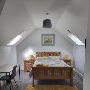 a bedroom with a bed and a table and chairs at Greenway Guesthouse in Mullingar