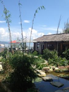 a house with a pond in front of it at 大理涵墅 HillSea in Dali
