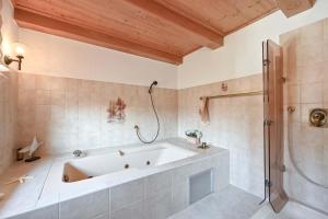 a large bathroom with a tub and a shower at Haus Bella in Schwangau +16 photos