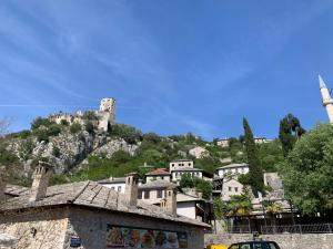 a town with a castle on top of a hill at Neretva View in Počitelj +7 photos