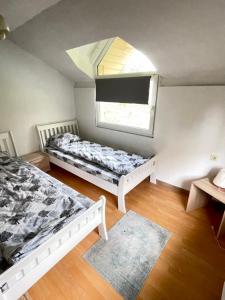 a small room with two beds and a window at Neretva View in Počitelj